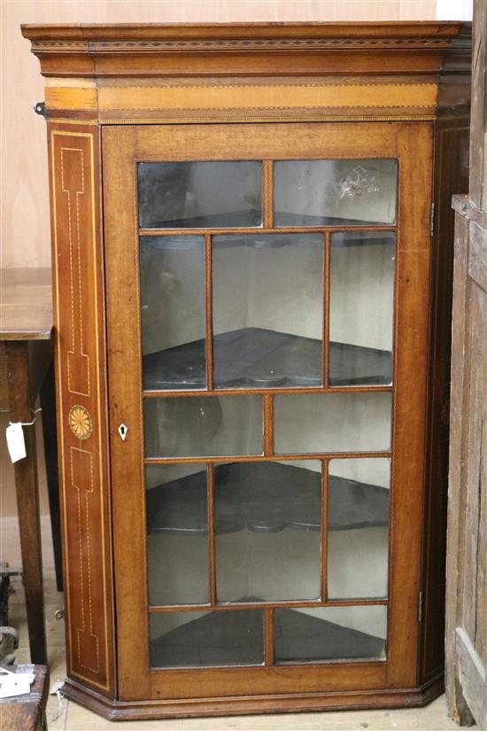 A George III inlaid corner cabinet W.84cm